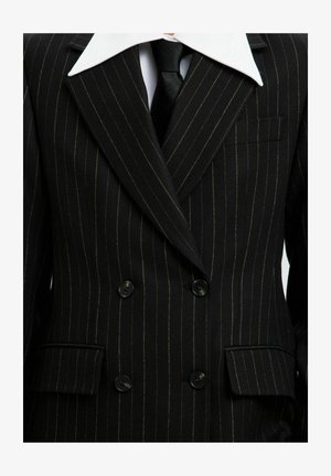 Black pinstriped double-breasted suit jacket with contrasting white collar, black buttons, and a chest pocket; fabric appears textured.