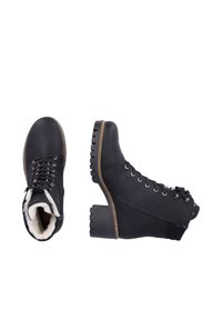 Black leather ankle boots with lace-up front, faux fur lining, block heel, and rugged outsole. Features silver eyelets and zipper detail.