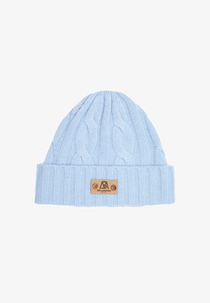 Cappello lavorato a maglia azzurro chiaro, sciarpa e guanti con un motivo a trecce. Ogni pezzo presenta una toppa in pelle marrone. Indossato con un cappotto nero.
