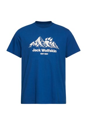 Maglietta di cotone blu a maniche corte, con grafica bianca di una montagna e testo "Jack Wolfskin EST 1981" sotto il disegno.