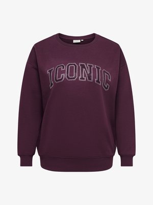 Tummanvioletti pyöreäkauluksinen collegepaita, jossa on rinnan päällä isolla sanalla "ICONIC" korotetut, strassikivillä koristellut kirjainä.