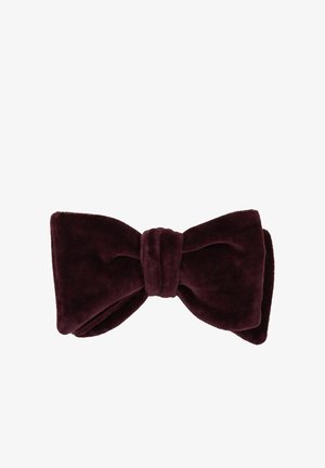 Burgundijas samta tauriņš ar mīkstu tekstūru, lielu tauriņu formu un centrālu mezglu. Gluda auduma virsma bez rakstiem vai metāla detaļām.