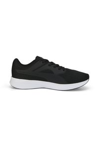Zapatilla deportiva negra con una parte superior de malla texturizada, que cuenta con una entresuela blanca y cordones planos, diseñada para ofrecer comodidad y soporte en el deporte.