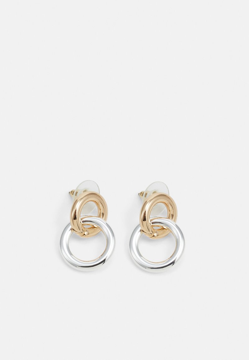 Gold and silver metal earrings featuring interlocking circular links, a polished finish, and stud backing for secure wear.