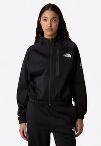 Black zip-up jacket with a hood, elastic waist, and cuffs. Features The North Face logo on the chest and sleeve, crafted from smooth fabric.