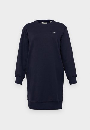 Navy sweatshirt dress in soft cotton blend. Features long sleeves, ribbed cuffs, and a round neck. Small logo detail on the chest.