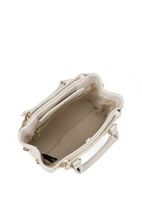 Crème-kleurige handtas gemaakt van gestructureerd materiaal, voorzien van goudkleurige ritsen, dubbele handvaten, een ruime binnenkant en een platte basis voor stabiliteit.