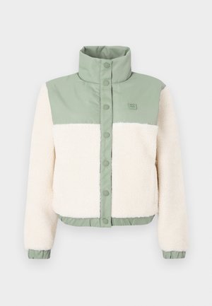 Giacca corta con corpo in morbido pile crema, spalle in nylon verde e colletto alla coreana con chiusura a bottoni. Orlo e polsini elasticizzati.