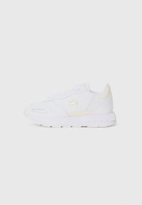 White athletic sneakers featuring a smooth leather upper, subtle beige accents, tonal laces, and a cushioned rubber sole.