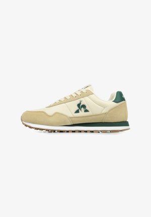 Beige and green sneakers featuring a combination of smooth leather and suede. Classic design with a rubber sole and logo detail on the side.