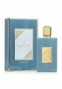 Blå mockalåda med gyllene accenter, inkluderar en matchande rektangulär flaska med ett texturerat gyllene lock och en emblemisk etikett.