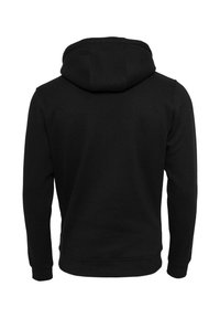 Hoodie noir à manches longues avec capuche intégrée, poignets côtelés et taille côtelée, présenté de dos sur un fond blanc uni.