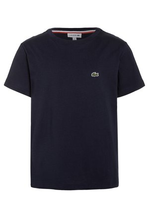 Mørkeblå bomulds-t-shirt med rund hals og korte ærmer. Har et lille grønt Lacoste-logo på brystet. Glat tekstur.