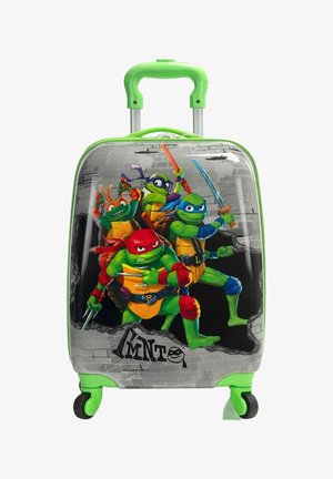 Valise pour enfant à poignée verte avec les personnages des Tortues Ninja en poses d'action sur un fond de mur en briques grises.