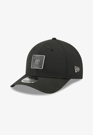 Black baseball cap with San Francisco 49ers logo patch on front and New Era logo on side, curved brim, and adjustable back strap.