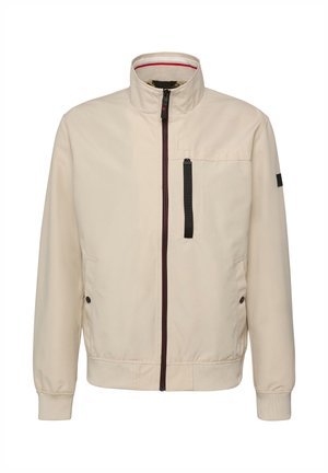 Beige Zip-Up-Jacke mit Stehkragen, schwarzem vertikalem Reißverschluss an der Brusttasche, zwei Seitentaschen mit Knöpfen sowie elastischen Bündchen und Saum.