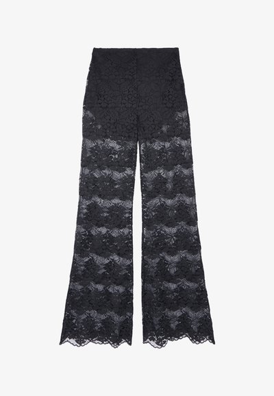 Pantalons larges en dentelle noire avec un design à motifs floraux et des bords ondulés, offrant une texture transparente tout au long.