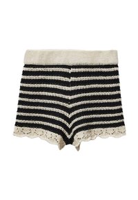 Shorts en tricot à rayures noir et crème avec un ourlet festonné. Le tissu présente une texture et une taille élastique.