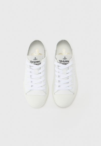 White sneakers made of leather with perforated accents. Flat laces, rounded toe, and "Vivienne Westwood" branding on the tongue. Smooth texture.