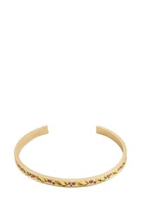 Gold metal cuff bracelet with small purple flowers and green vine patterns engraved along the outer edge. Open-ended design.