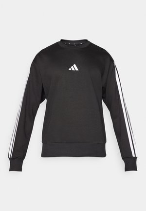 Black sweatshirt with long sleeves, white three-stripe accents on arms, and a small white logo on the chest. Soft fabric with a round neck.