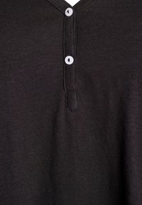 Must lühikeste varrukatega särk, valmistatud tekstuurse kangaga, millel on V-kaelus ja kolme valge nupuga plastron.