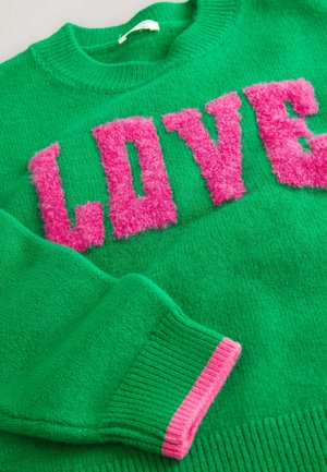 Green sweater with a round neckline, featuring fluffy pink "LOVE" lettering and ribbed pink accents on the cuffs. Soft texture.