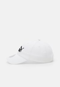 Gorra de béisbol blanca hecha de algodón, con el logo bordado en negro de "PUMA" en la parte frontal. Visera curva y seis orificios de ventilación.