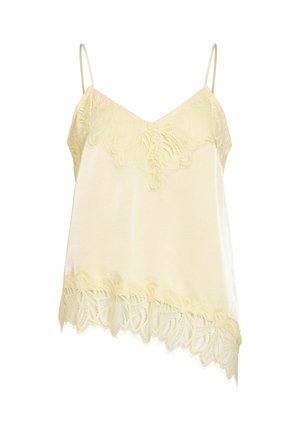 Camisole en soie crème avec bordure en dentelle le long du décolleté en V, de l'ourlet et fines bretelles, avec un bord inférieur asymétrique.