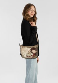 Umhängetasche mit einem bunten Design, das ein cartoonhaftes Mädchen und den Schriftzug "Know Yourself" zeigt. Hergestellt aus robustem Stoff, mit Reißverschluss.