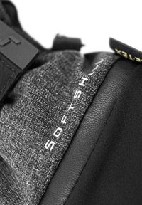 Textured gray fabric with black accents and a smooth black section. Features the word "SOFT" in white text on one side.