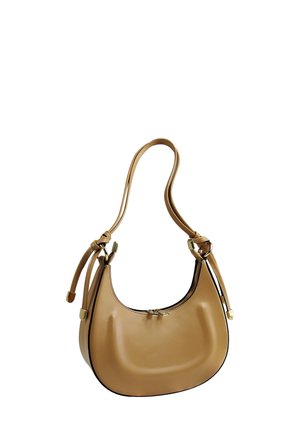 Tan leather hobo bag with a curved shape, double strap, zipper closure, and contrasting black edging. Smooth texture with gold hardware accents.