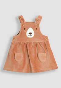 Vestido de pana con diseño de cara de oso, color durazno, tirantes ajustables, botones de madera y bolsillos frontales. Presenta una falda acampanada.
