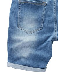 Denim shorts in light blue with a rolled hem, featuring single back pocket with a pointed flap and slight fading for texture.