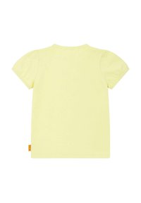 T-shirt gialla a maniche corte con scollatura tonda e maniche a sbuffo. Materiale in cotone morbido; presenta un piccolo tag con logo sul lato.