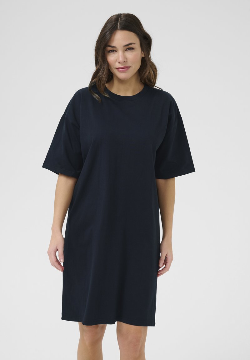 Navy t-shirt dress made of soft cotton, featuring short sleeves, a relaxed fit, and a straight hemline. Minimalist design with no patterns.