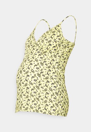 Top de maternidade amarelo com padrão floral preto, decote em V e alças finas, ajustado para uma silhueta justa na barriga.