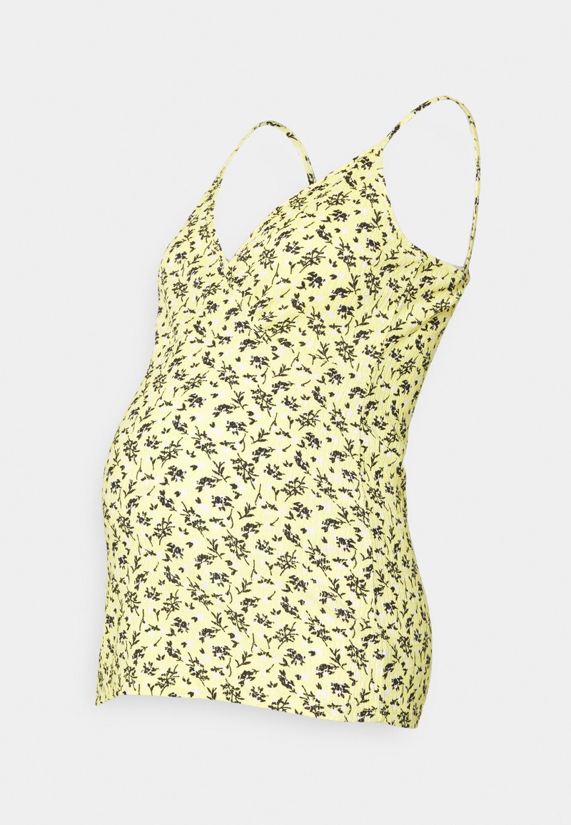 Top de maternidade amarelo com padrão floral preto, decote em V e alças finas, ajustado para uma silhueta justa na barriga.