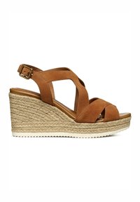 Sandalo con zeppa in suede marrone, con cinturini incrociati, soletta avvolta in juta e fibbia alla caviglia regolabile. Suola in gomma piatta per una migliore trazione.