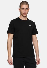 Musta puuvillapaita lyhyillä hihoilla ja pyöreällä kauluksella. Rinnassa on pieni valkoinen Fila-logo. Sileä pinta.