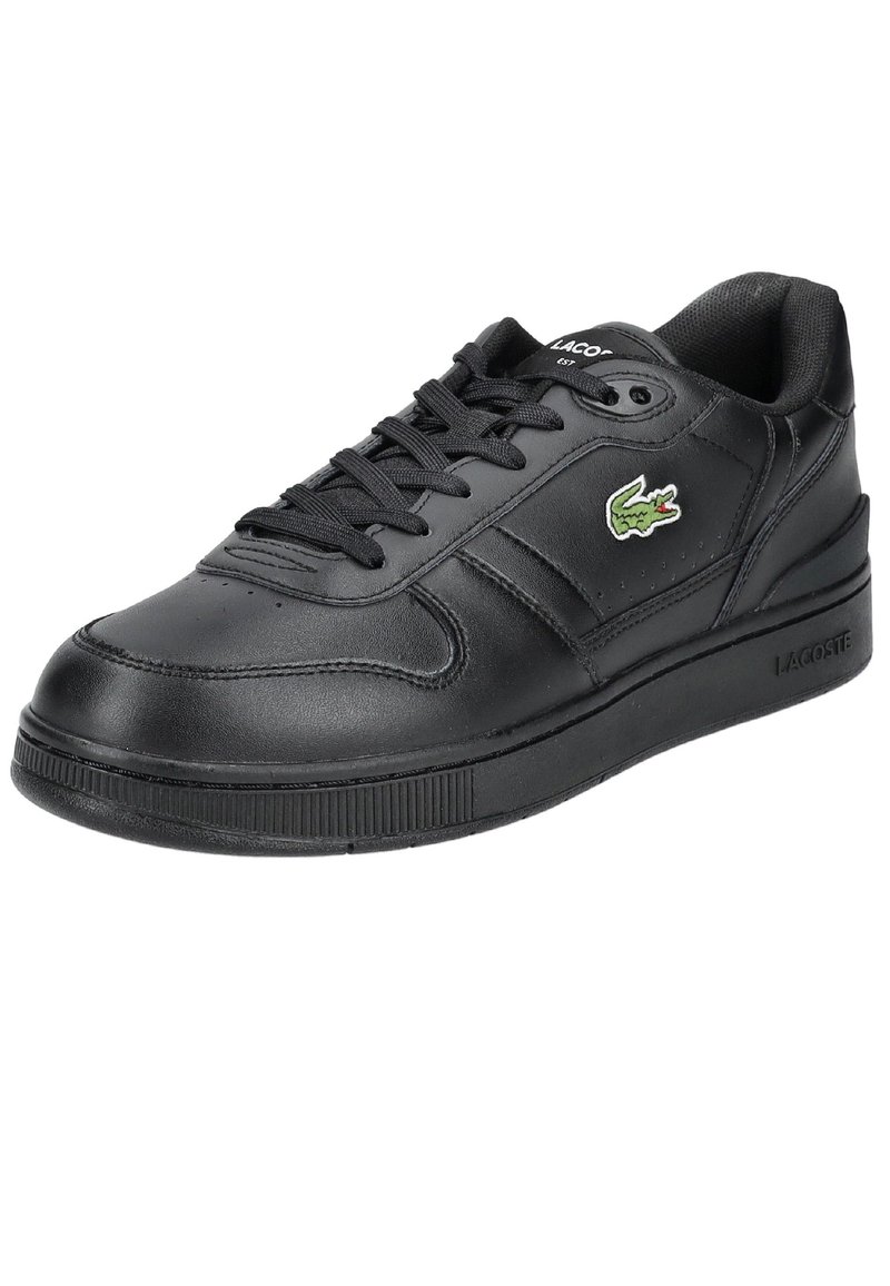 Black leather sneaker with lace-up closure, padded collar, textured rubber sole, and green crocodile logo accent on the side.