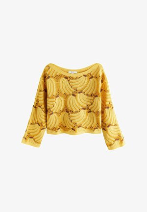 Keltainen neulottu pitkähihainen villapaita, jossa toistuva banaanikuvio ja leveä pääntie.