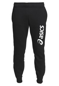 Černé sportovní kalhoty vyrobené z měkké látky, s elastickým pasem, zúženými nohavicemi a bílým logem "Asics" potištěným vertikálně na boku.