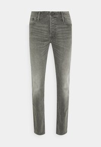 Pánské šedé oprané džíny slim fit s pěti kapsami a zapínáním na knoflík, vystavené rozložené na bílém pozadí.