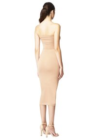 Abito midi aderente senza spalline in tessuto nude con dettaglio arricciato. Presenta una texture liscia e una silhouette sotto il ginocchio.