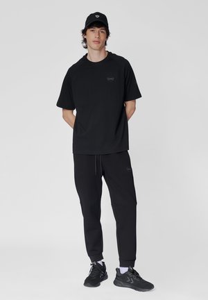 REGULAR - Pantalon de survêtement - black