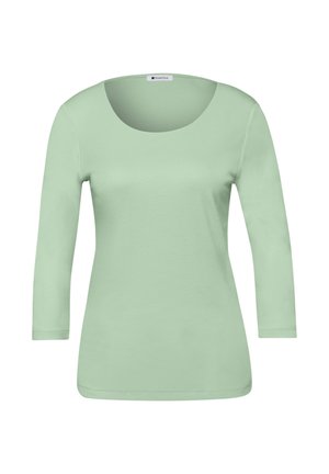 Miętowo-zielona bluzka z długim rękawem i zaokrąglonym dekoltem, wykonana z miękkiego materiału. Posiada dopasowany krój oraz gładkie, równomierne przeszycia.