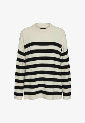 Juostuota megztinis kremine ir juoda spalvomis, su raštuotais paviršiais, ilgomis rankovėmis ir apvalia iškirpte. Juostos yra plačios ir vienodai išdėstytos.