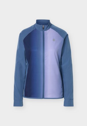 Veste légère pour femme à fermeture éclair, manches longues, col montant, et design en blocs de couleur bleue.