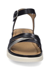 Czarne skórzane sandały z metalowymi akcentami, regulowanym paskiem na kostce, wyściełaną wkładką i elastyczną białą podeszwą. Skrzyżowane paski z przodu.